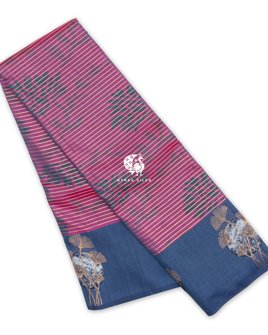 Magenta and Slate Blue Ikat Ginkgo Moon Kanchipuram silk saree, folded to show the magenta ikat body with zari stripes and the slate blue border with ginkgo moon motifs — pure silk with pure zari, Ayraa Silks