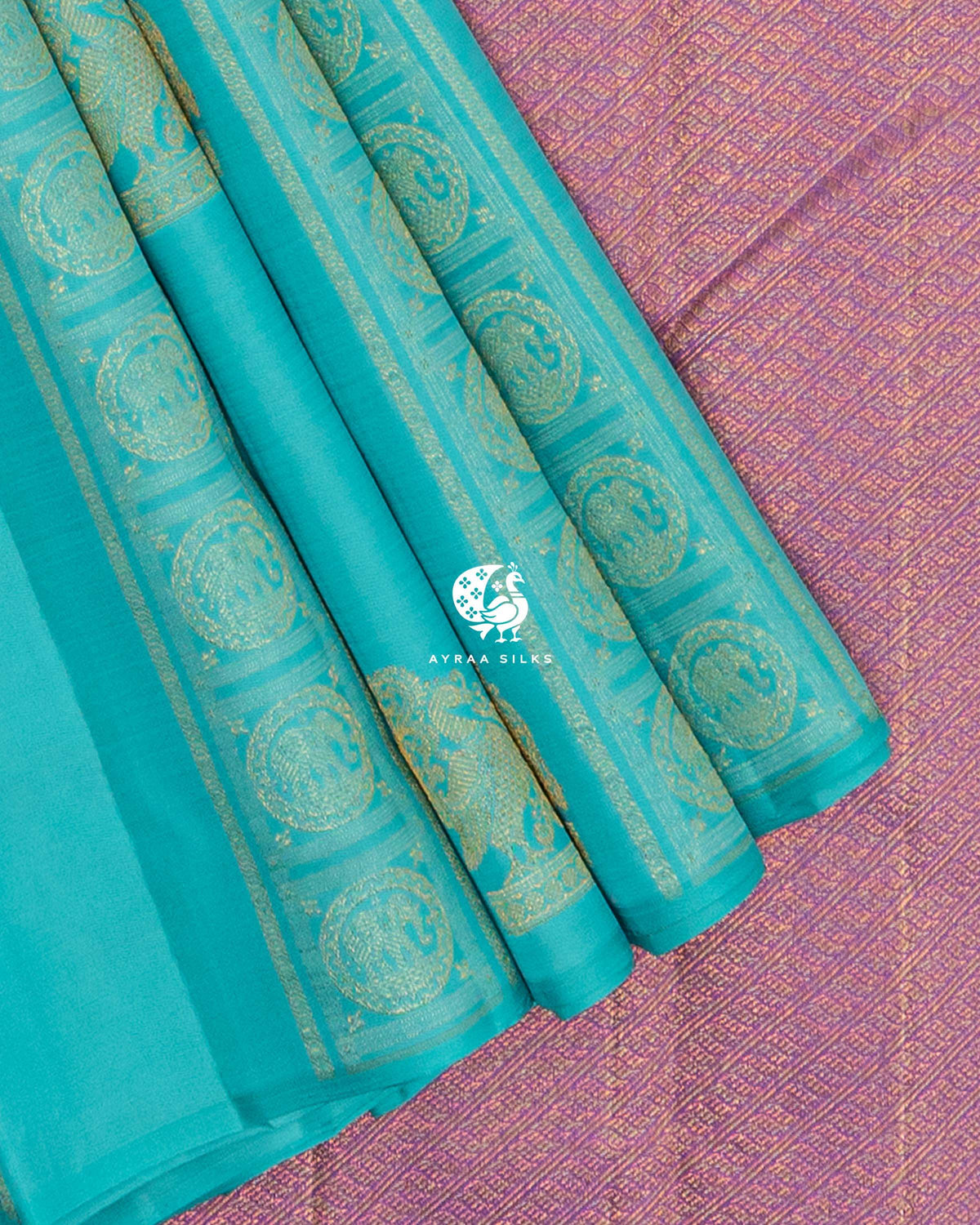 Close view of elephant Chakra medallion bands on turquoise Kanchipuram silk against the lavender zari pallu