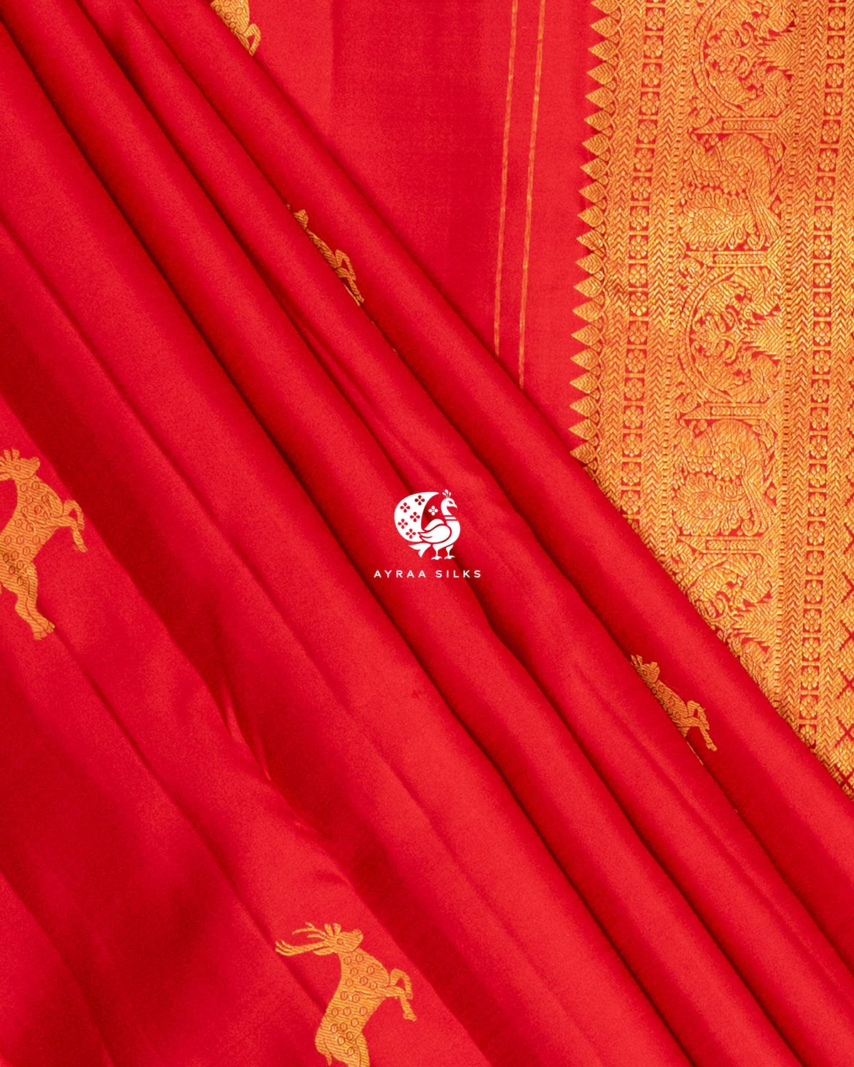 Red pleats with deer zari buttas beside the Mayil (peacock) zari side border and temple edge of the pallu
