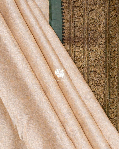 Cream zari Manga brocade pleats beside the Mayil (peacock) zari side border of the pallu