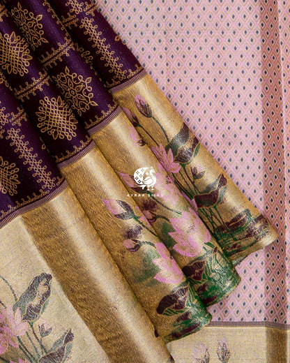 Close view of the gold zari tissue border with Thamarai (lotus) flowers, buds and leaves beside jamun purple kolam silk