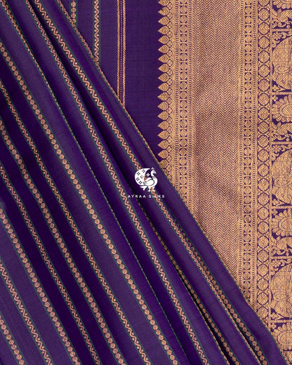 Purple silk with floral and wave zari stripes in diagonal folds beside the zari pallu band