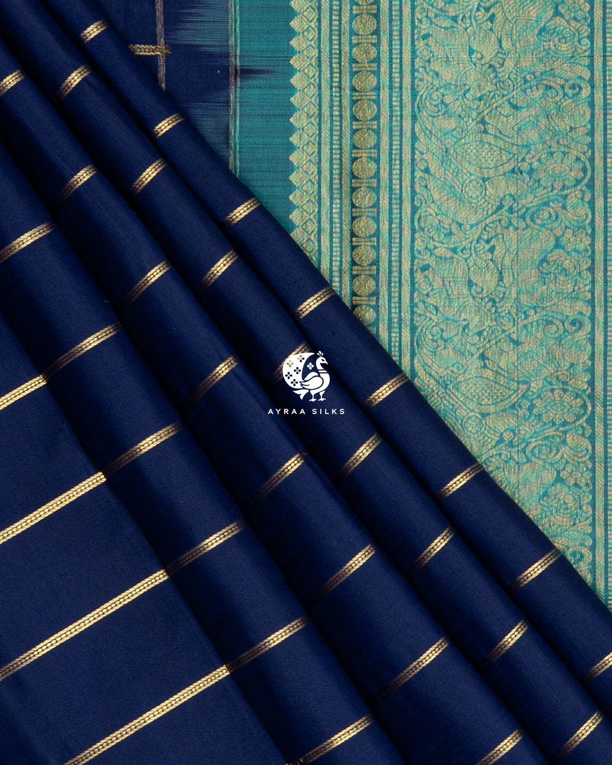 Navy blue silk pleats with gold zari stripes beside the teal pallu band woven with peacock zari motifs