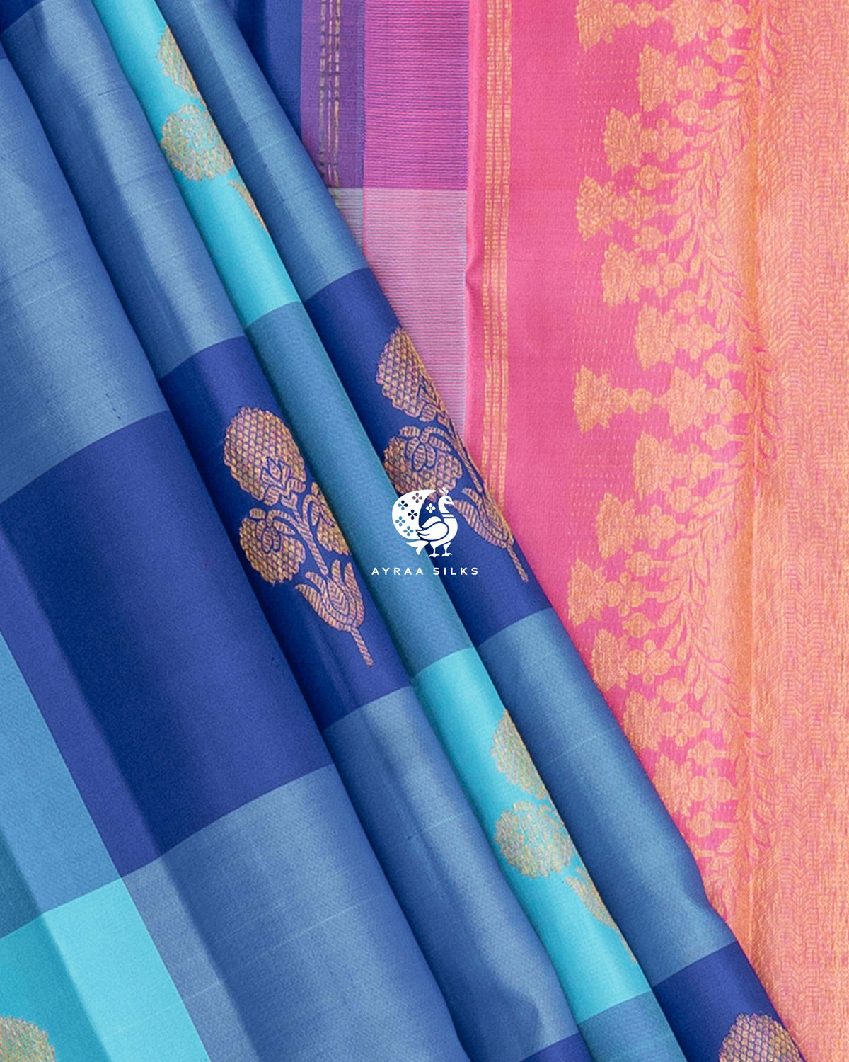 Blue Kattam pleats beside the floral zari side border of the pink pallu on a pure Kanchipuram silk saree