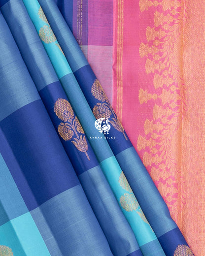 Blue Kattam pleats beside the floral zari side border of the pink pallu on a pure Kanchipuram silk saree
