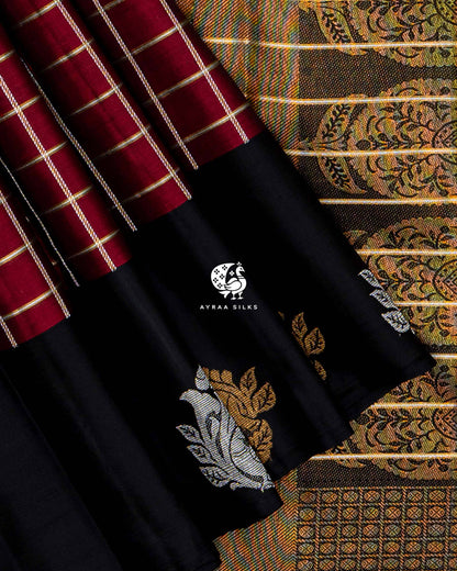 Close view of gold and silver zari Mayil (peacock) motifs on the black border beside the zari medallion pallu