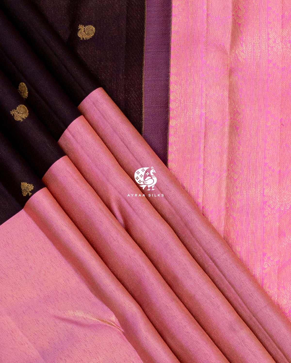 Rose pink zari band and coffee brown silk pleats with peacock zari buttas beside the bright pink zari pallu border