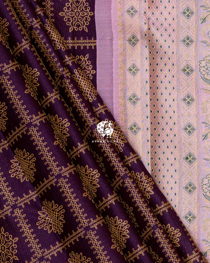 Jamun purple silk with zari kolam motifs in diagonal folds beside the pastel pink zari pallu with diamond and floral bands