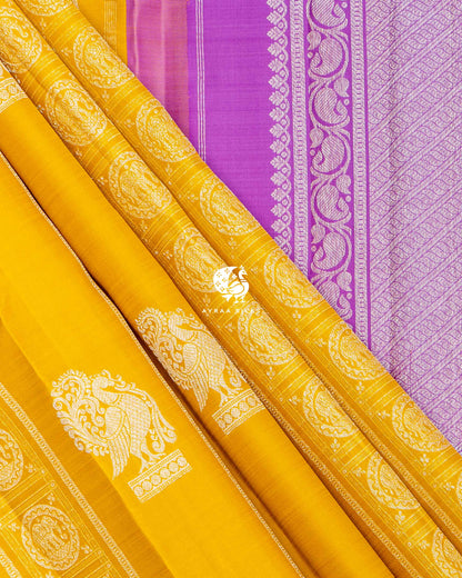 Mustard pleats with Yanai zari medallions beside the purple paisley vine border of the lavender pallu