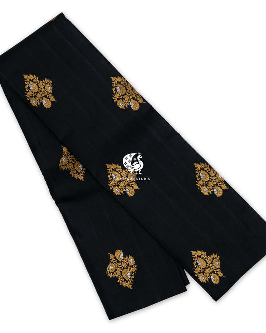 Black pure Kanchipuram silk saree folded, with large floral vine buttas in gold zari and silver zari flowers