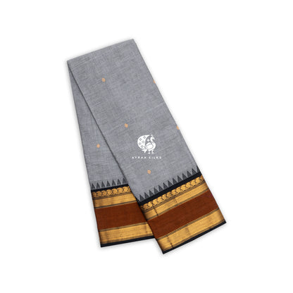 Grey Kanchi cotton saree folded, rust and black temple border with gold zari buttas — Ayraa Nithya by Ayraa Silks