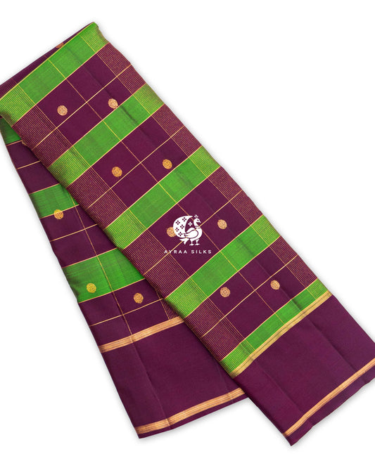 Wine and Green Kattam Kanchipuram silk saree, folded, with green checks, round zari buttas and a wine border
