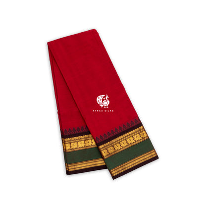 Red Kanchi cotton saree folded, black temple border with gold zari paisleys and green band — handwoven pure cotton by Ayraa Silks