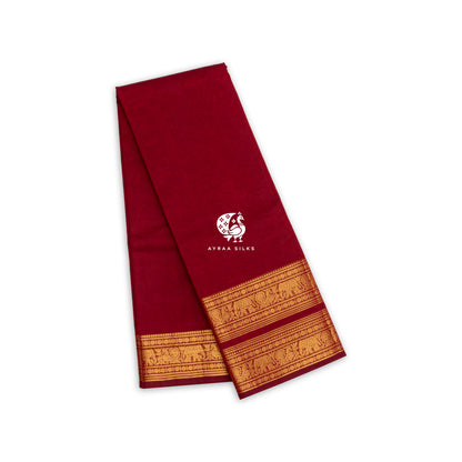 Deep red handwoven Kanchi cotton saree with a broad gold zari elephant border, folded
