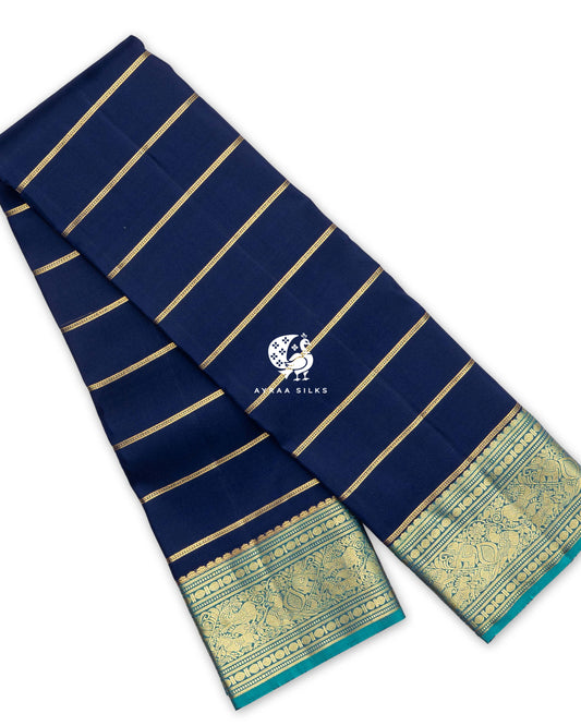 Navy Blue Zari Vari Kanchipuram silk saree, folded, with gold zari stripes and a teal zari border