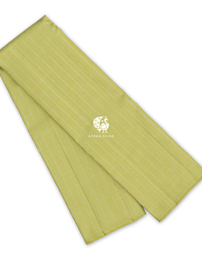 Pista green pure Kanchipuram silk saree folded, with silver zari Vari (stripes) running down the body