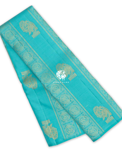 Turquoise Mayil Chakra Kanchipuram silk saree, folded, with Mayil (peacock) zari buttas and zari bands of Chakra medallions