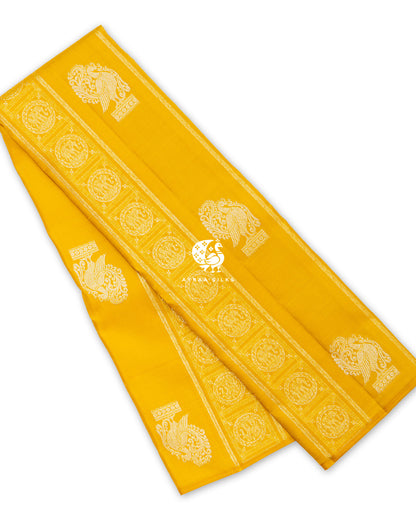 Mustard Annam Yanai Kanchipuram silk saree folded, with silver zari Annam (swan) buttas and Yanai (elephant) medallion bands