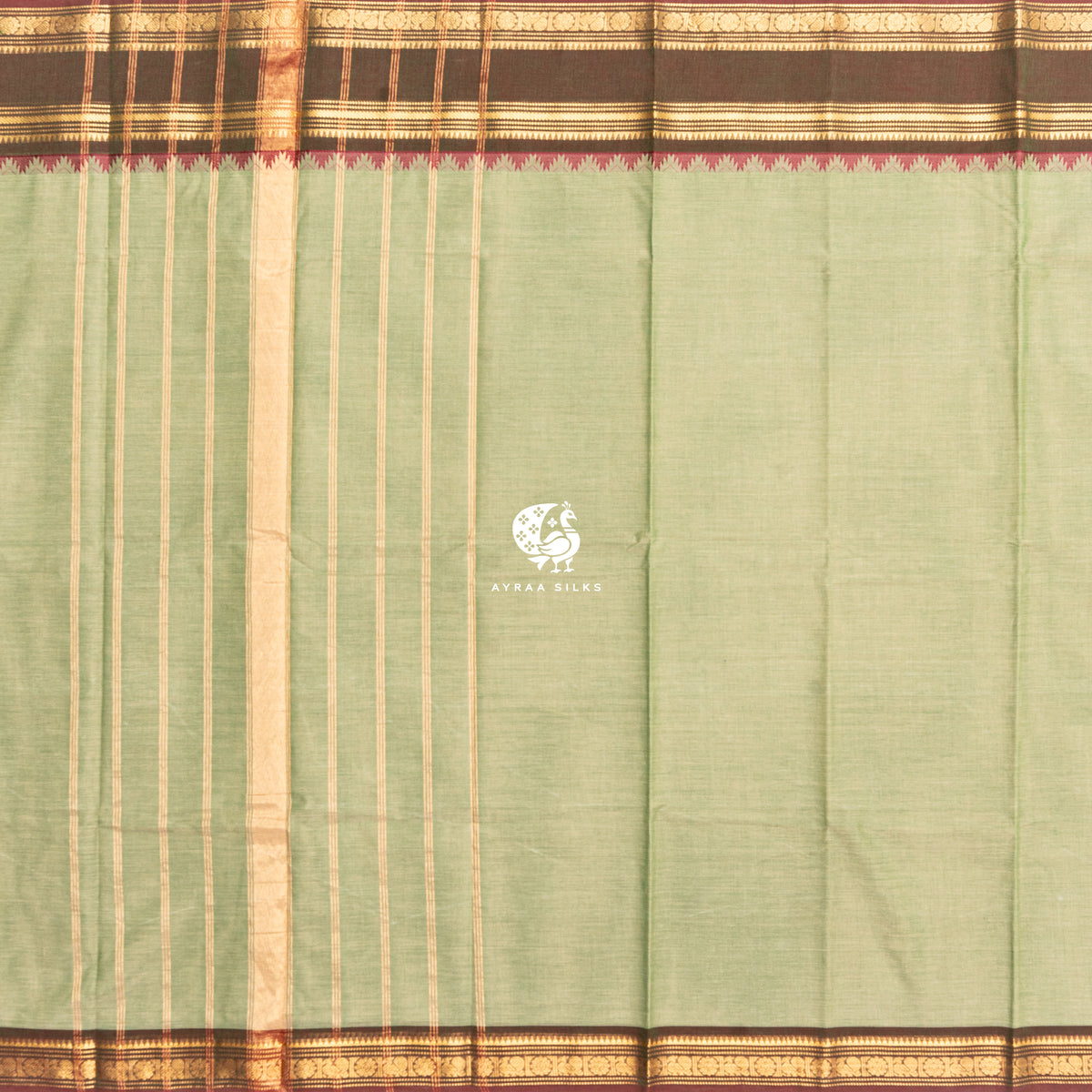 Pista green Kanchi cotton saree laid flat, pallu with zari lines and the brown zari temple border