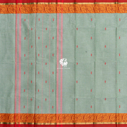 Sage green Kanchi cotton saree laid flat, pallu with stripes and orange thread borders on both sides