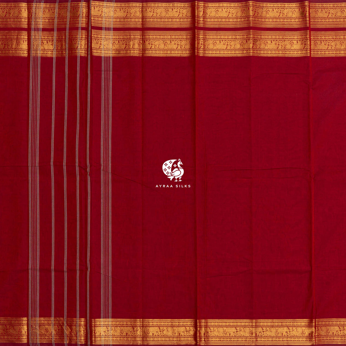 Red Kanchi cotton saree laid flat, pallu with stripes and the gold zari elephant border