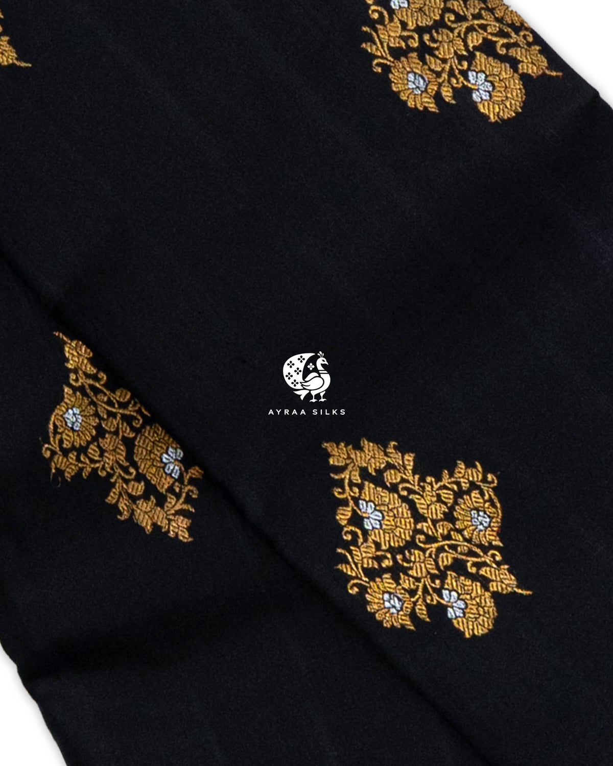 Close view of gold zari floral vine buttas with silver zari flowers on black pure Kanchipuram silk