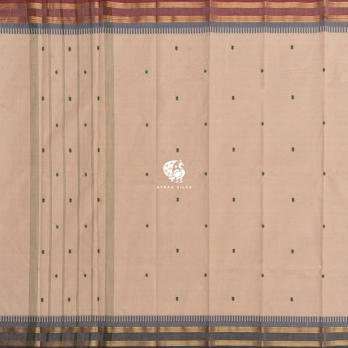 Beige cotton saree laid flat, green buttas and striped lines along the pallu and two Ganga Jamuna borders — maroon on one side, charcoal grey on the other