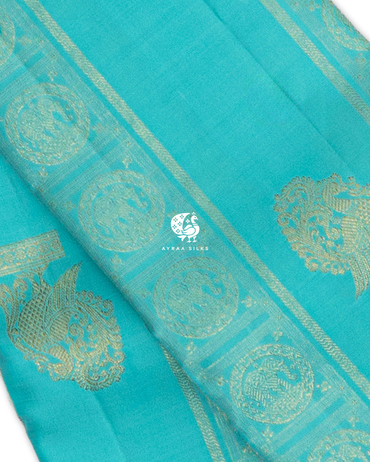Close view of Mayil (peacock) zari buttas and Chakra medallions on a turquoise blue pure Kanchipuram silk saree
