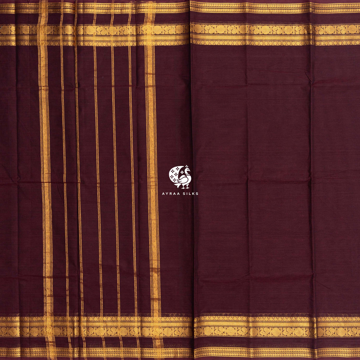 Maroon Kanchi cotton saree laid flat, pallu with zari lines and the self colour gold zari border