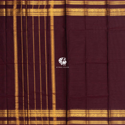 Maroon Kanchi cotton saree laid flat, pallu with zari lines and the self colour gold zari border