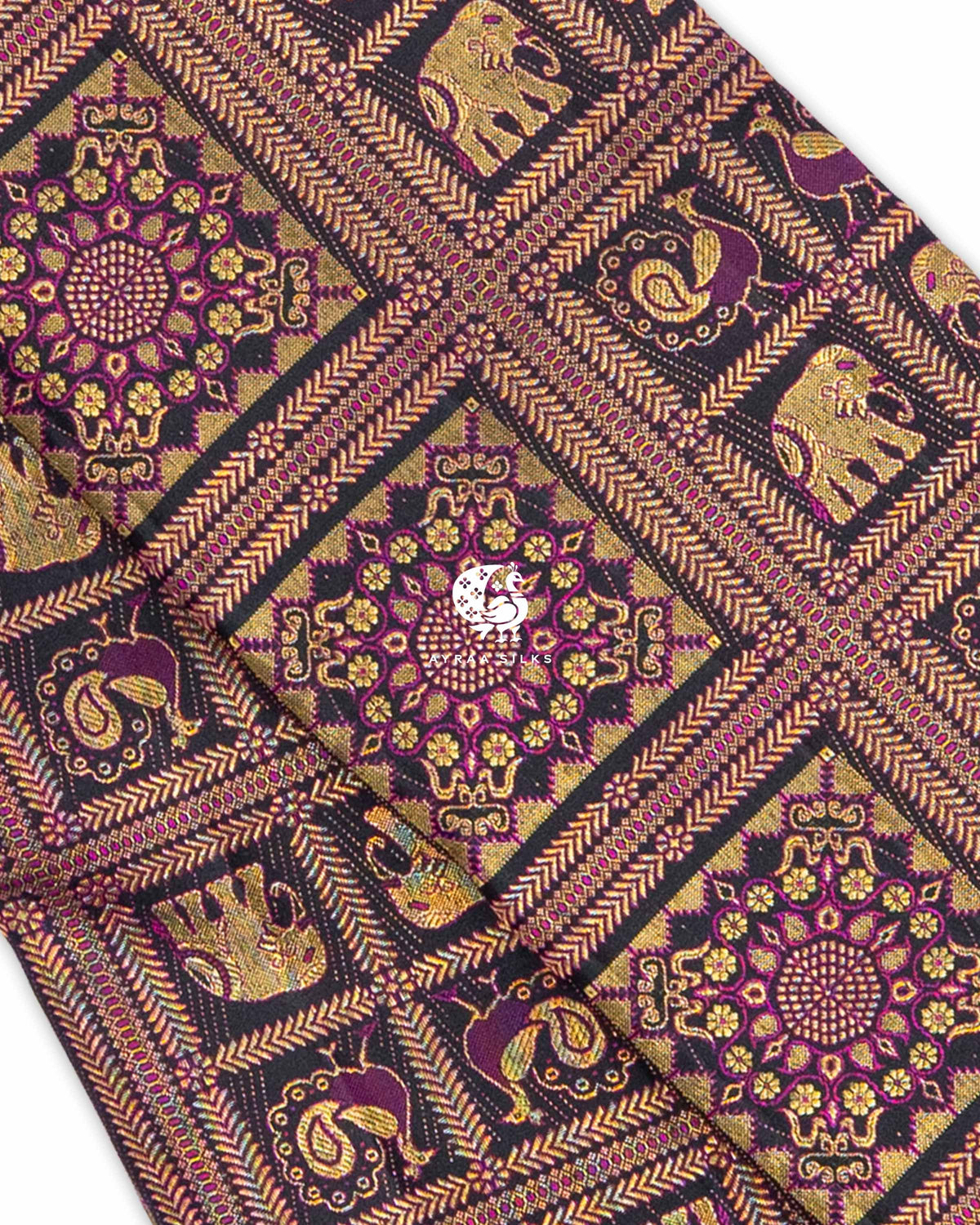 Close view of zari brocade with purple threadwork, showing floral medallions and Yanai (elephant) and Mayil (peacock) motifs