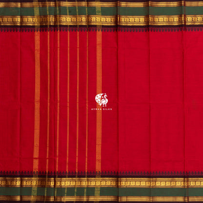 Red Kanchi cotton saree laid flat, pallu with gold zari lines and black temple borders on both sides