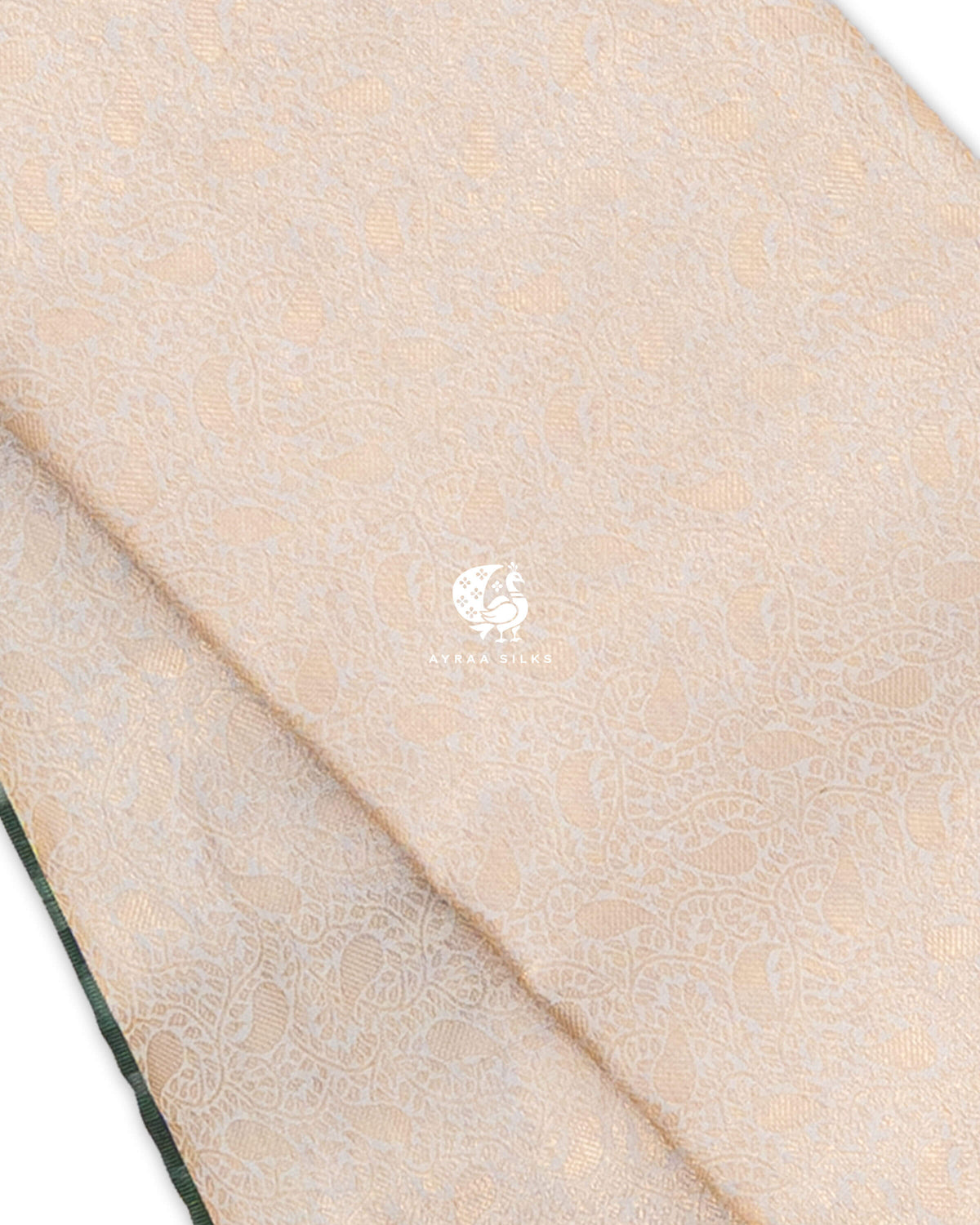 Close view of zari Manga (paisley) motifs and floral vines woven across cream pure Kanchipuram silk