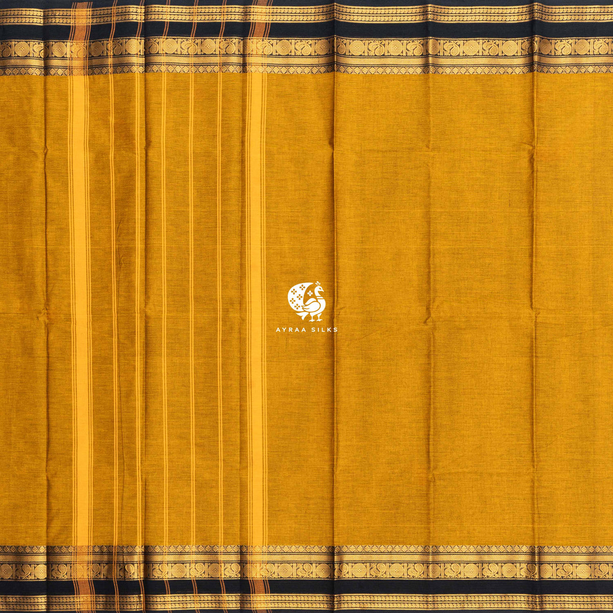 Mustard Kanchi cotton saree laid flat, pallu with stripes and the black and gold zari peacock border