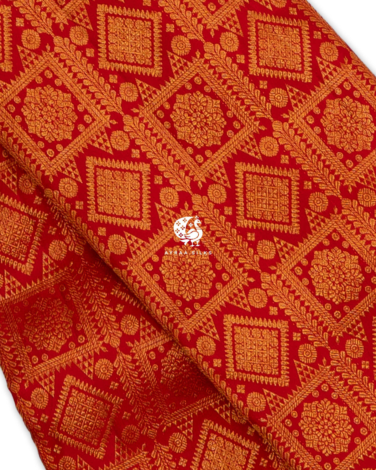 Close view of zari brocade on red pure Kanchipuram silk, with floral medallions in square and diamond frames and leaf vines