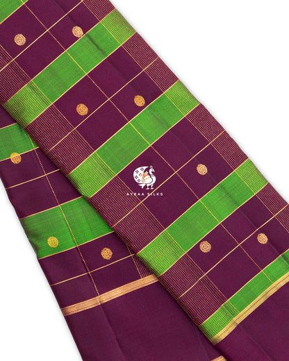 Close view of wine and green Kattam (checks) with round floral zari buttas and fine dotted zari lines on pure Kanchipuram silk