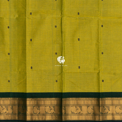 Bottle green buttas woven across the mehendi green cotton body