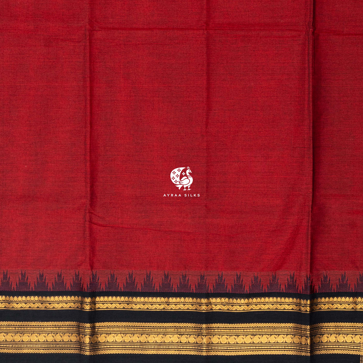 Plain red cotton body meeting the black temple kumbam border in gold zari