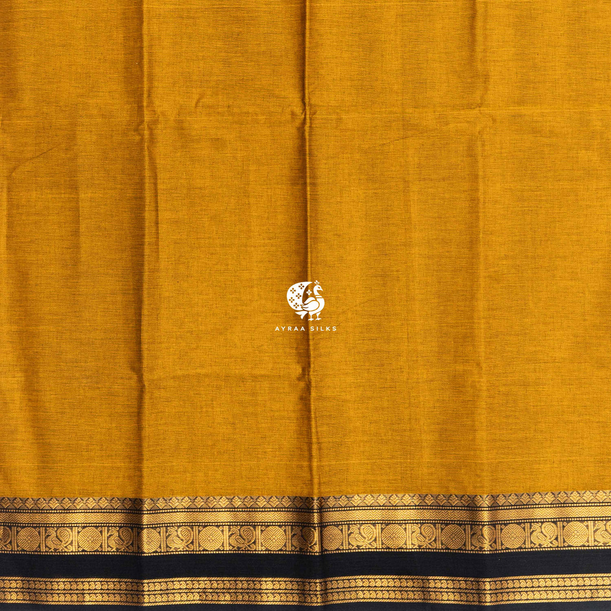 Plain mustard cotton body meeting the black and gold zari border