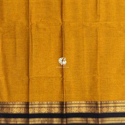 Plain mustard cotton body meeting the black and gold zari border