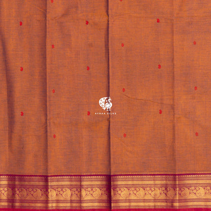 Red thread buttas across the rust body, meeting the magenta zari border