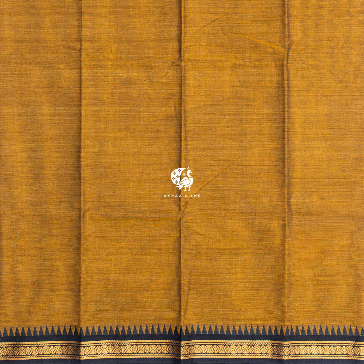Plain mustard cotton body meeting the black temple kumbam border in zari