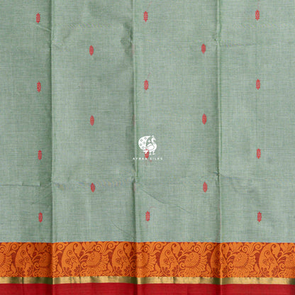 Red thread buttas across the sage green body, meeting the orange paisley border