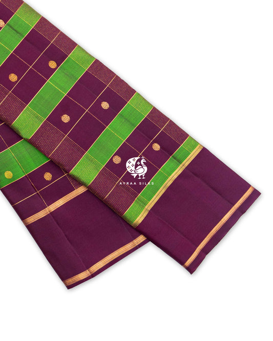 Wine Kanchipuram pattu saree in green Kattam (checks) with round zari buttas and a plain wine border edged in zari lines