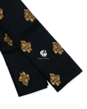 Black and Lavender Floral Butta Kanchipuram silk saree folded, showing the borderless black body with gold zari floral buttas