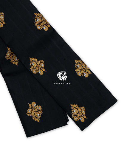 Black and Lavender Floral Butta Kanchipuram silk saree folded, showing the borderless black body with gold zari floral buttas