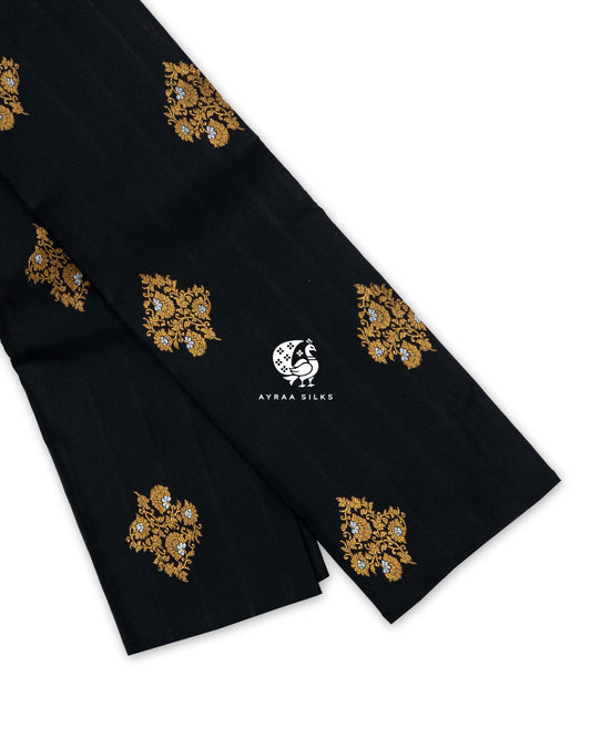 Black and Lavender Floral Butta Kanchipuram silk saree folded, showing the borderless black body with gold zari floral buttas