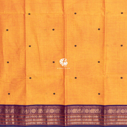 Mustard Kanchi cotton saree laid flat, pallu with purple buttas and Ganga Jamuna elephant zari borders
