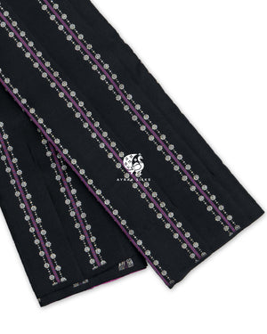 Black Kanchipuram pattu saree with purple stripes and floral zari buttas, showing the borderless edge