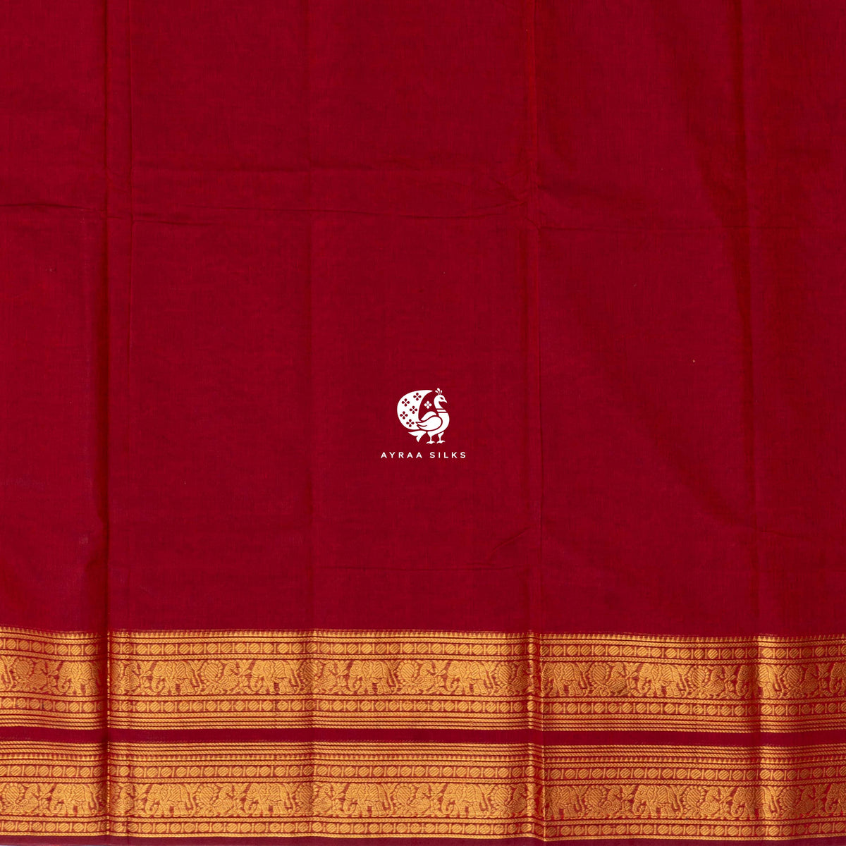 Plain red cotton body meeting the broad self colour gold zari border